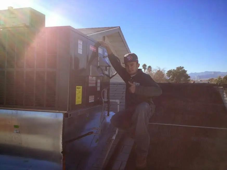 HVAC technician performing Boiler Repair on a rooftop unit in Foster City